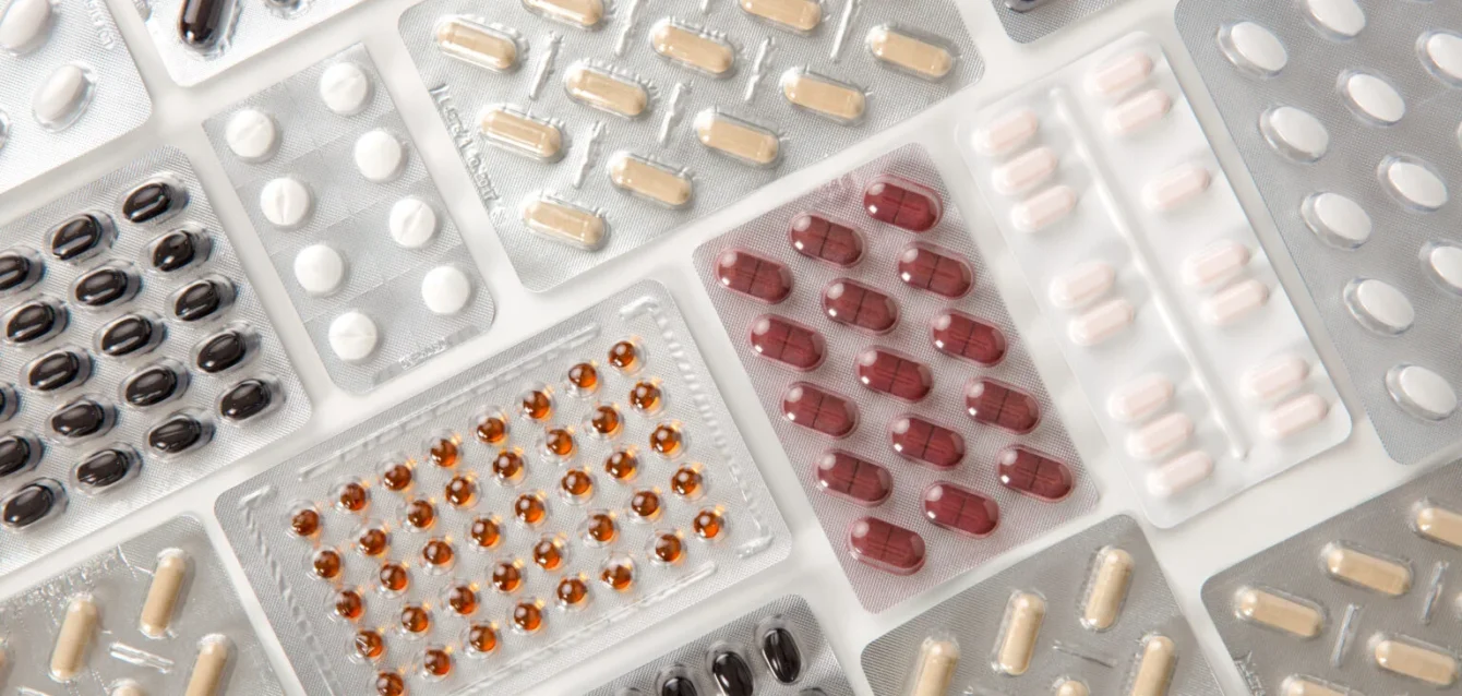colorful-pills-in-blister-packs-on-table colorful-pills-in-blister-packs-on-table